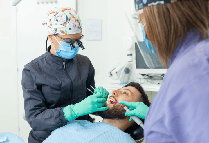 A dentist checking a patient's alignment during a clear aligner review